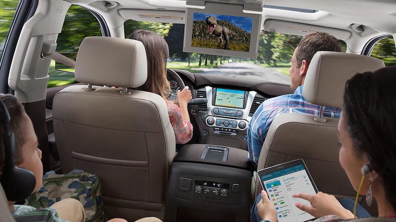 A family enjoying the entertainment in the 2018 Chevy Tahoe.