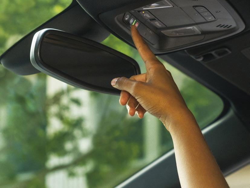 Person pressing the OnStar button